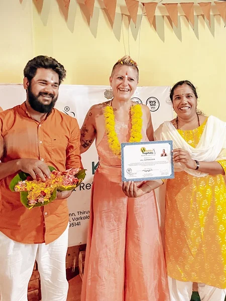 Yoga students in class with certifications awarded after the training