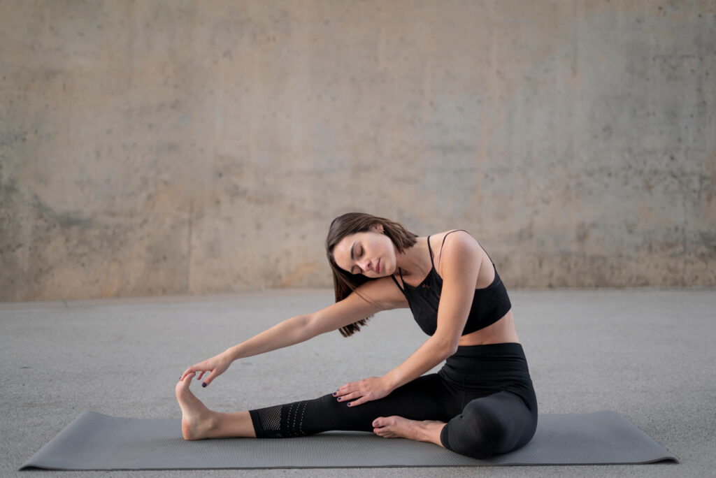 Woman practicing a seated side stretch yoga pose