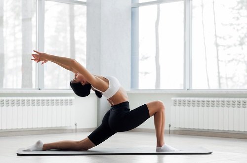 Women Practicing Anjaneyasana to Improve Spinal Mobality, Posture