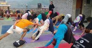 Group of people practicing yoga outdoors on a rooftop