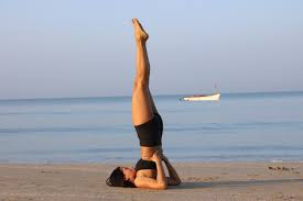 Woman practicing shoulder stand yoga pose (Sarvangasana) 