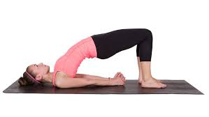 Woman practicing Setu Bandhasana (Bridge Pose)