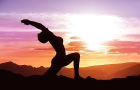 Woman performing a yoga pose at sunrise