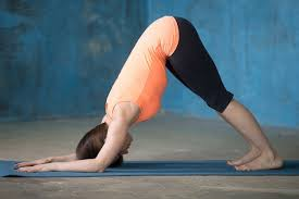 Woman performing Setubandhasana (Pelvic Tilt Pose) on a yoga mat