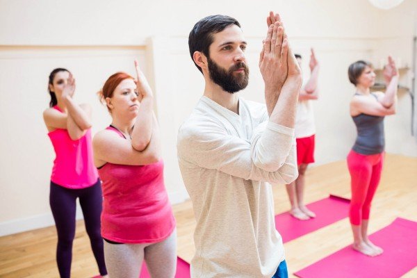 Group of People Practicing Garudasana (Eagle Pose) Yoga  In Kerala
